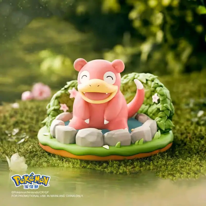 Pokémon Nature Figure featuring Slowpoke in a serene garden setting with stones and greenery.