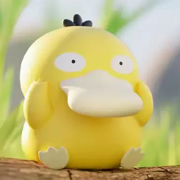 Pokémon Mini Figure Blind Box featuring a cute yellow Psyduck figure on a wooden surface in nature.