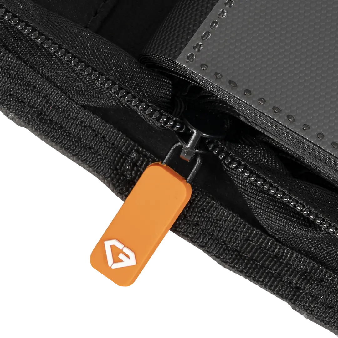 Close-up of the zipper on the 12 Pocket XL Card Binder, featuring a vibrant orange pull tab.