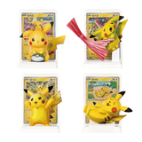 Collection of Pikachu figurines with trading cards, showcasing various poses and expressions in vibrant colors.