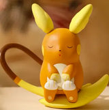 Lovely Pokémon Figure of Raichu sitting contentedly on a banana, perfect gift for Pokémon fans.