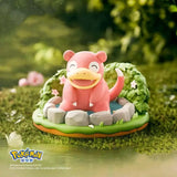 Pokémon Nature Figure featuring Slowpoke in a serene garden setting with stones and greenery.