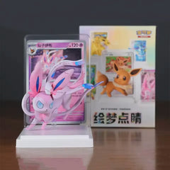 Pokémon Eeveelutions Blind Box [Live] featuring a beautifully sculpted Sylveon figure with cards in the background.